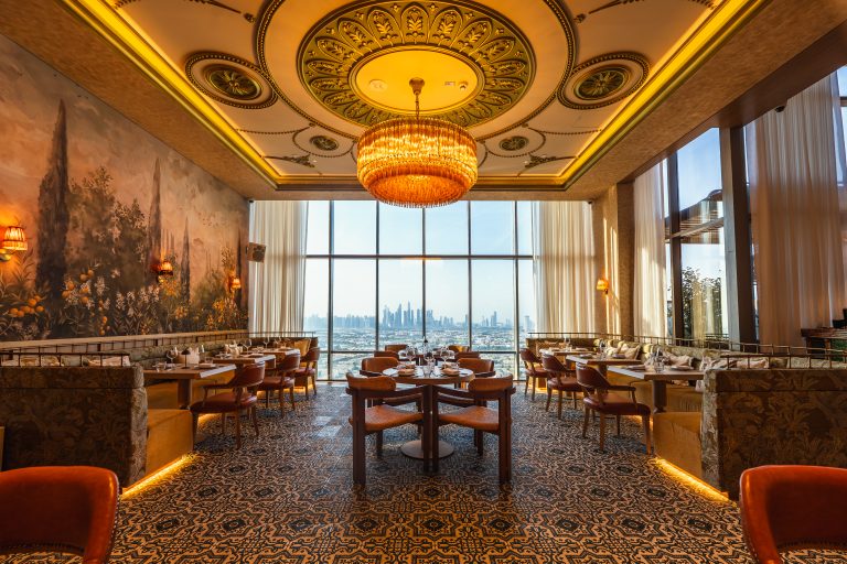 The Orilla dining room with a domed ceiling light and a skyline view through the windows
