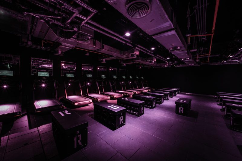 Rows of treadmills and plyo boxes in the 1Rebel studio at ICD Brookfield Place
