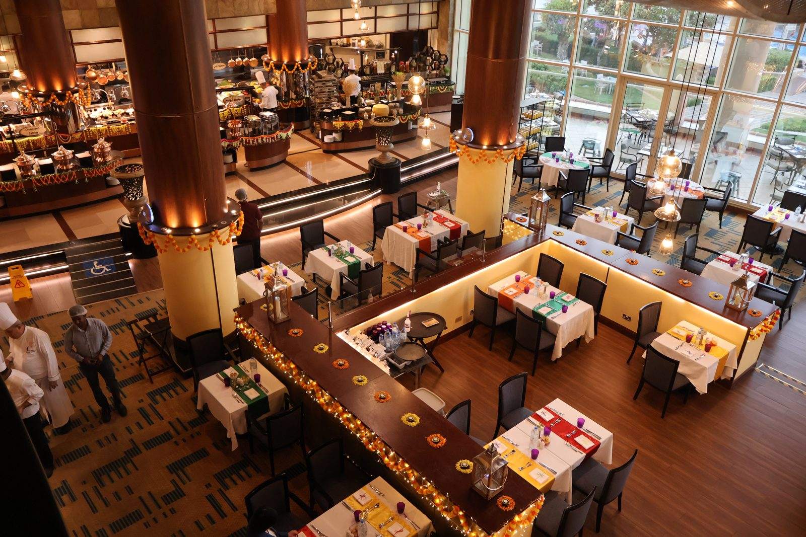 Sevilla Restaurant at Al Raha Beach Resort and Spa dressed for Diwali, with marigold garlands along the buffet counters