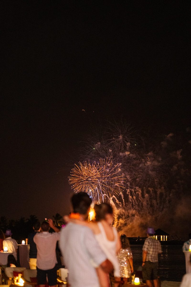 Guests watch fireworks at night at an Atmosphere resort in the Maldives