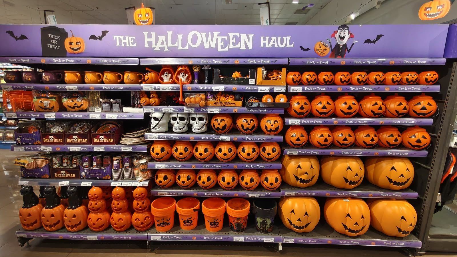Shelves of orange pumpkin buckets and Halloween decorations under The Halloween Haul sign at Choithrams