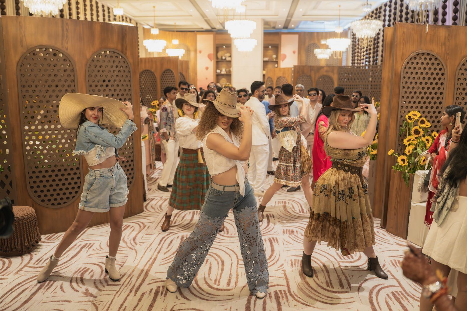 Guests in cowboy hats and denim dancing at a themed celebration designed by Envelop