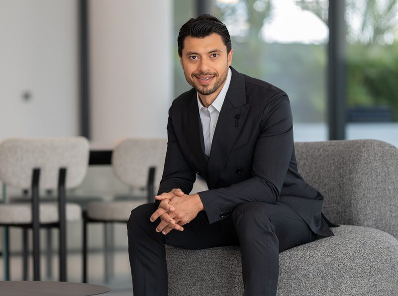 Firas Al Msaddi, founder and CEO of fäm Properties, seated in a dark suit