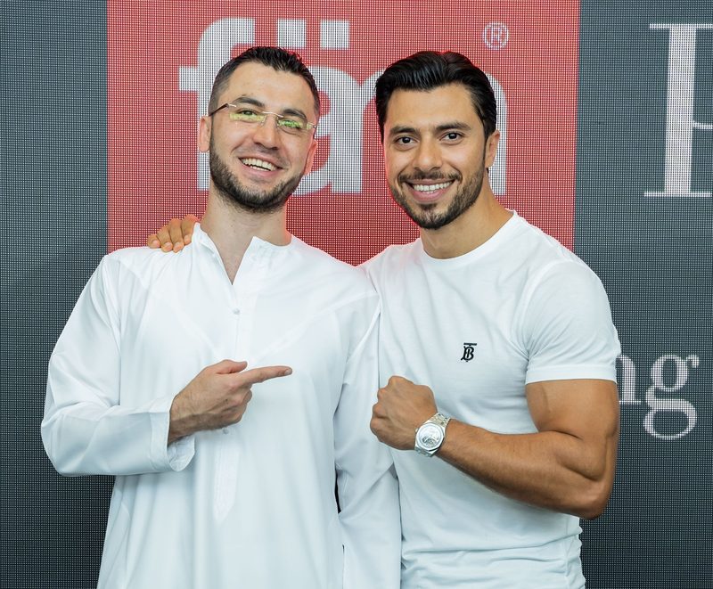 Fateh Al Msaddi and Firas Al Msaddi smiling in front of a red fäm backdrop