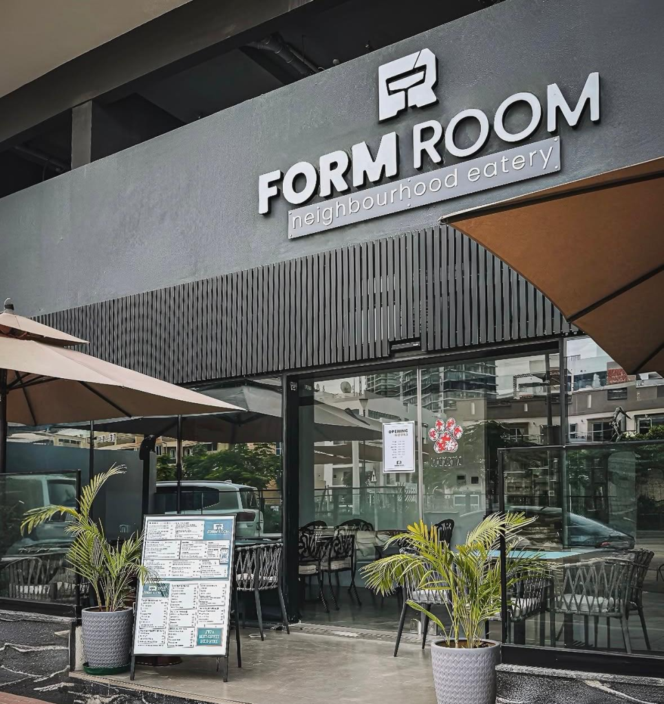 The storefront of Form Room neighbourhood eatery with outdoor tables and a menu board