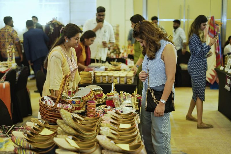 Visitors browsing decorative handcrafted products on a stall at a previous Miracle exhibition