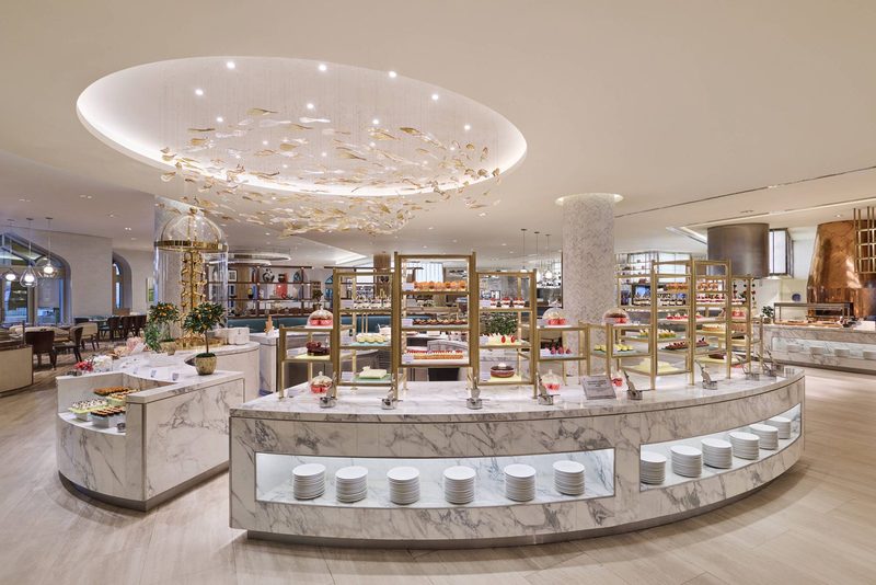 The central buffet counter under a sculptural ceiling light at Saffron