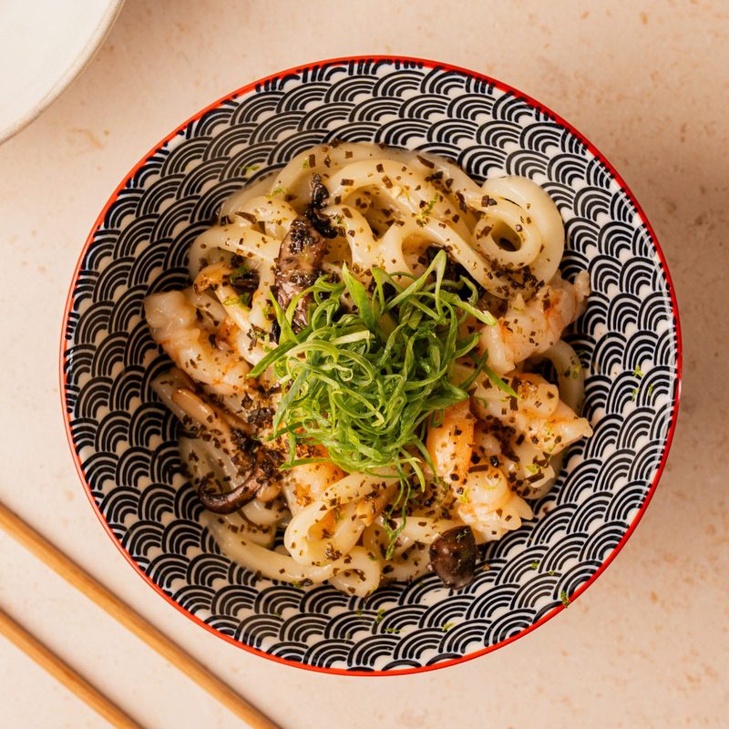 Udon noodles with shrimp, mushrooms and spring onion in a patterned bowl, from SLRP’s new October dishes