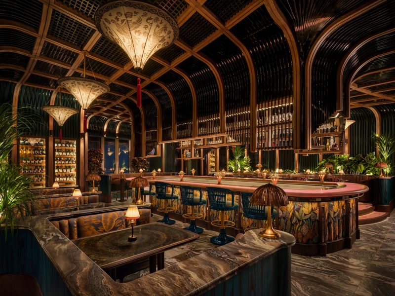 Bar seating with lanterns and low tables at TATTU Dubai