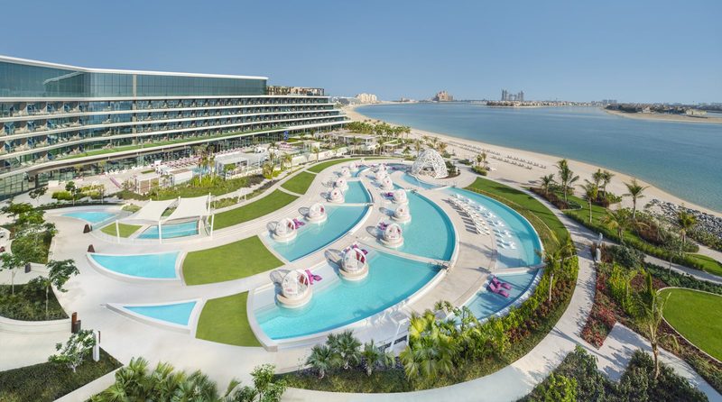Aerial view of W Dubai The Palm with its pools, sun loungers and beach on Palm Jumeirah